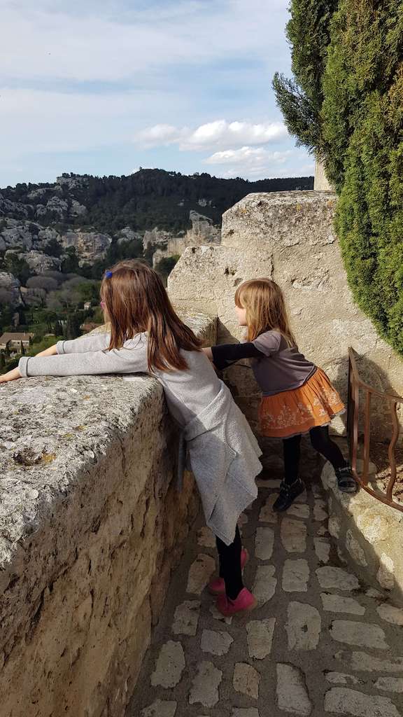 2 sisters looking at the view at the Baux de Provence Carrières des Lumières in Provence, France.